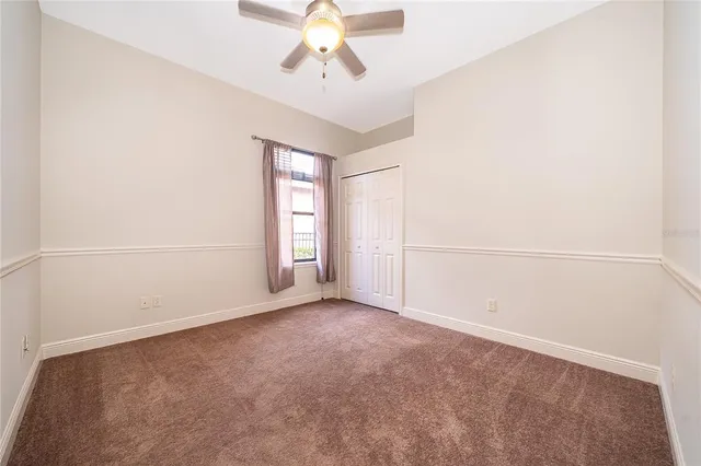 an empty room with a empty space and a ceiling fan