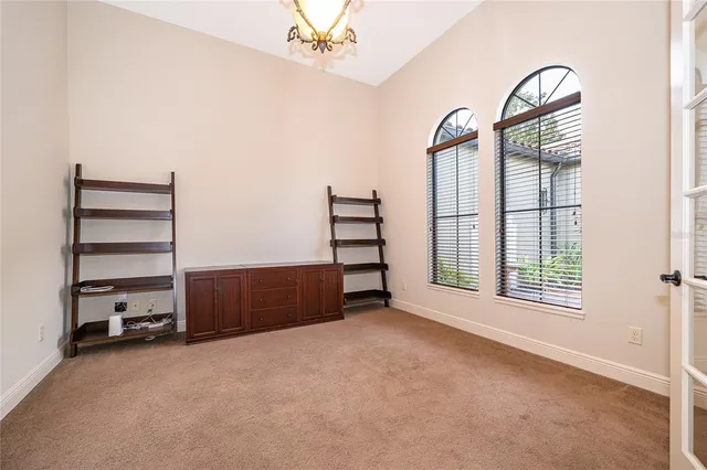 an empty room with windows and closet