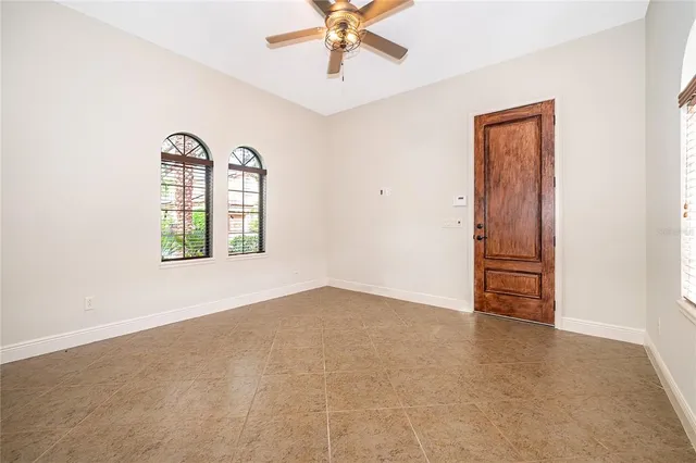 an empty room with windows and closet