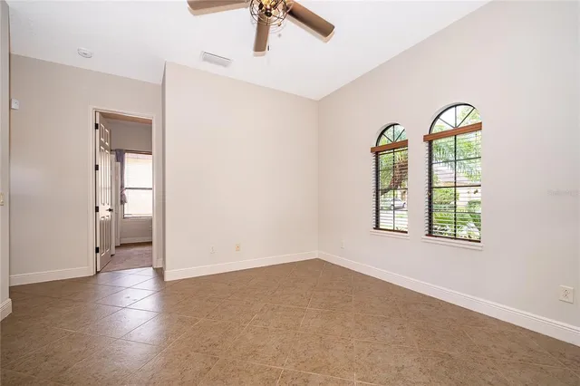 an empty room with a window and wooden floor
