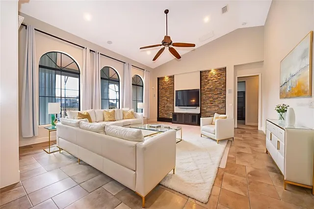 a living room with furniture a fireplace and a flat screen tv