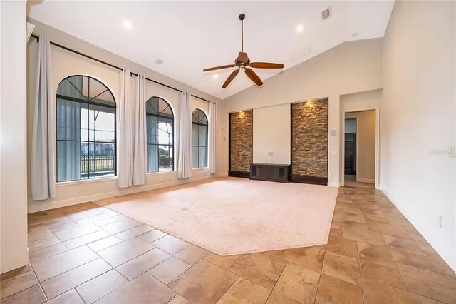 a view of an empty room with window and cabinet