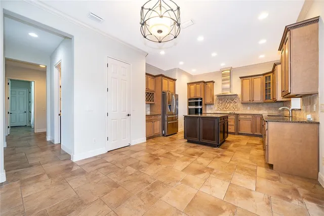 a large kitchen with cabinets and stainless steel appliances