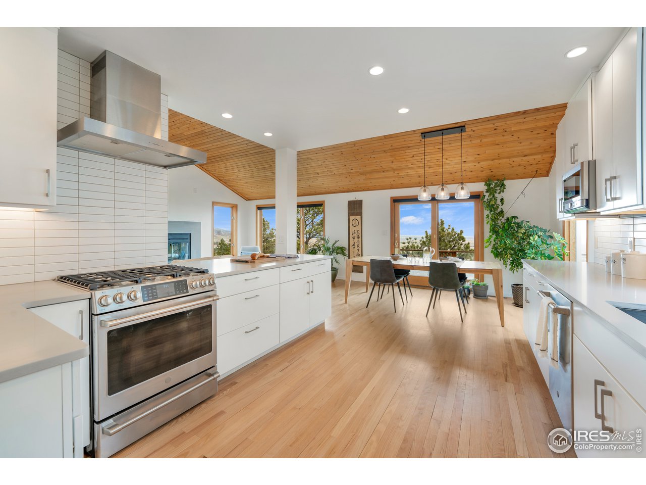 9042 Thunderhead Drive Boulder, CO 80302 - Photo 8 of 40 a open kitchen with stainless steel appliances granite countertop a stove and a wooden floors