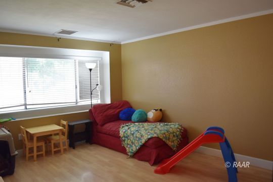 624 South Gemstone Street Ridgecrest, CA 93555 - Photo 2 of 13 a living room with furniture and a window