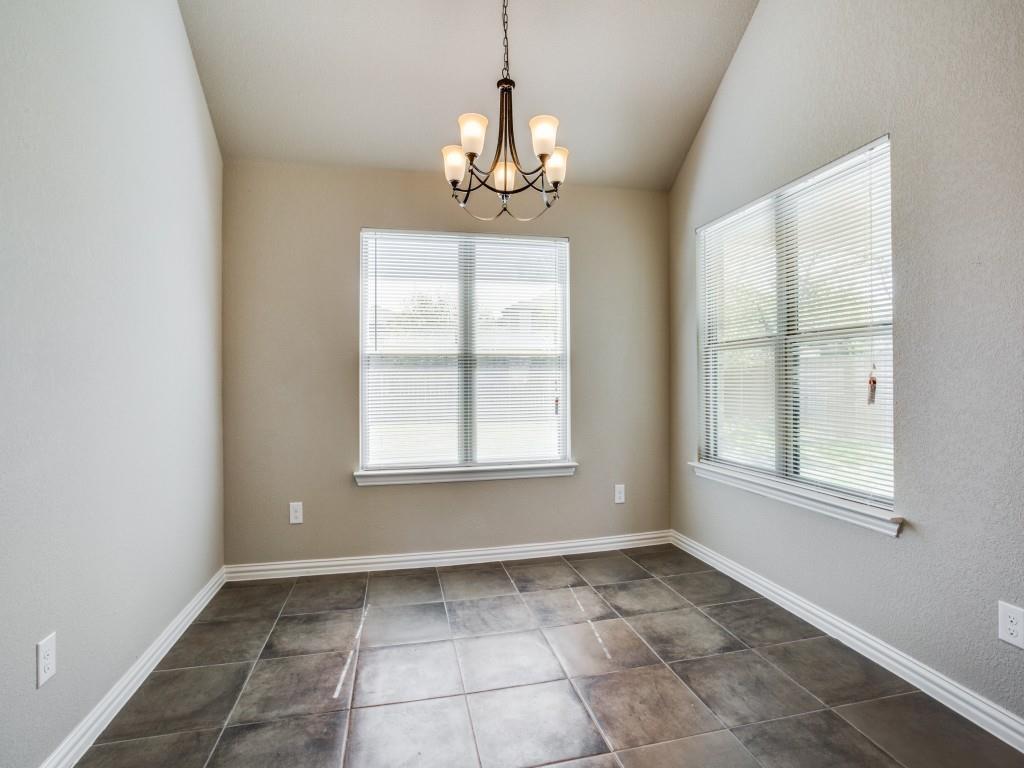 4113 Bridle Path Lane Sanger, TX 76266 - Photo 11 of 25 an empty room with windows and chandelier
