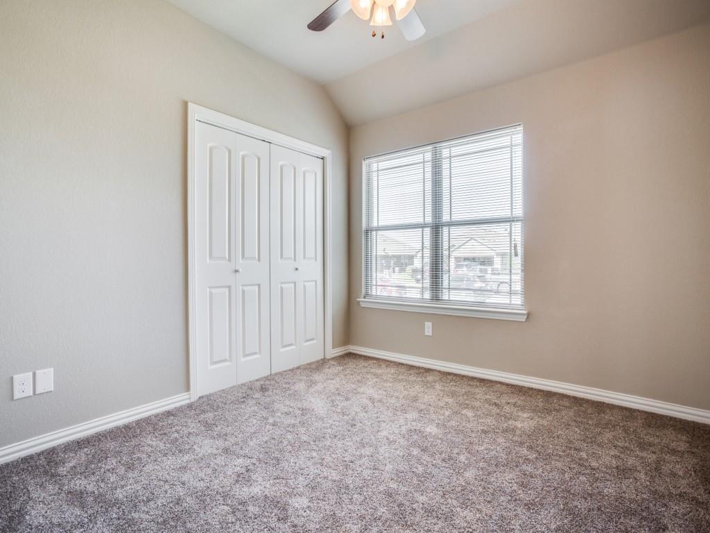 4113 Bridle Path Lane Sanger, TX 76266 - Photo 14 of 25 an empty room with windows and chandelier fan