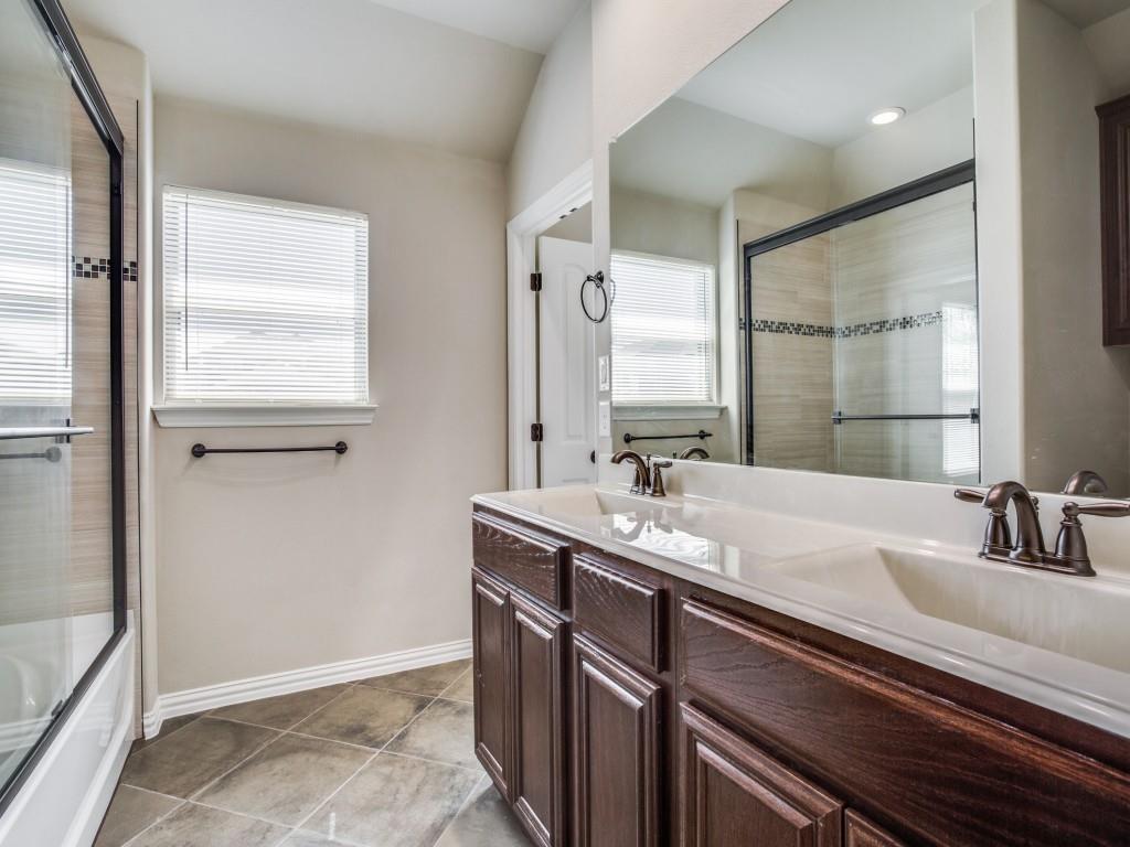 4113 Bridle Path Lane Sanger, TX 76266 - Photo 16 of 25 a bathroom with a double vanity sink and mirror