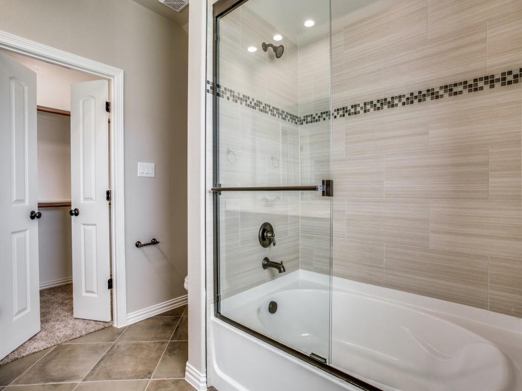 4113 Bridle Path Lane Sanger, TX 76266 - Photo 17 of 25 a bathroom with a bathtub and a shower