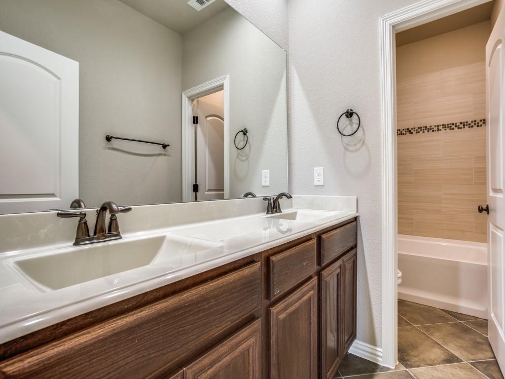 4113 Bridle Path Lane Sanger, TX 76266 - Photo 19 of 25 a bathroom with a sink and a mirror