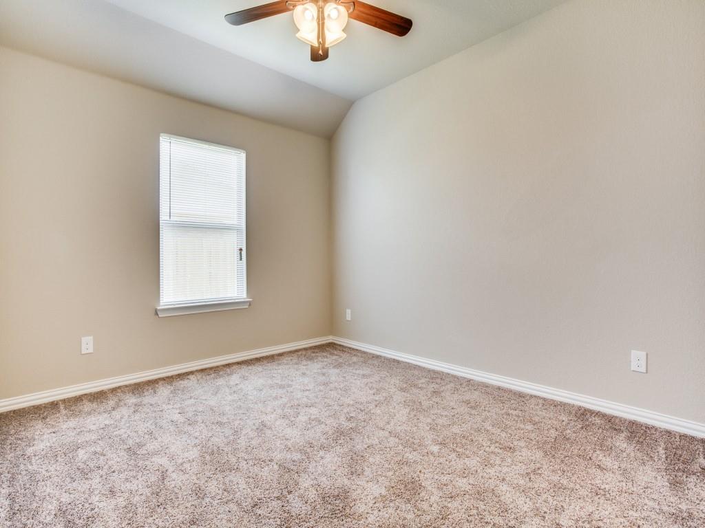 4113 Bridle Path Lane Sanger, TX 76266 - Photo 20 of 25 an empty room with a chandelier fan and windows
