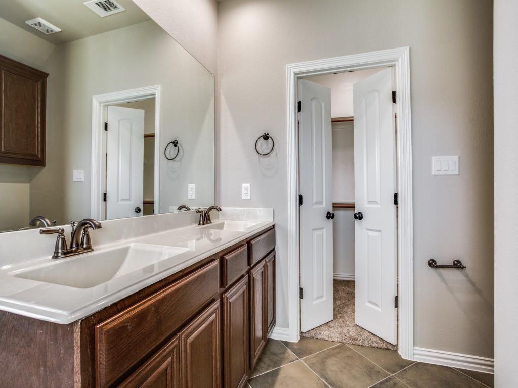 4113 Bridle Path Lane Sanger, TX 76266 - Photo 21 of 25 a bathroom with a sink and a mirror