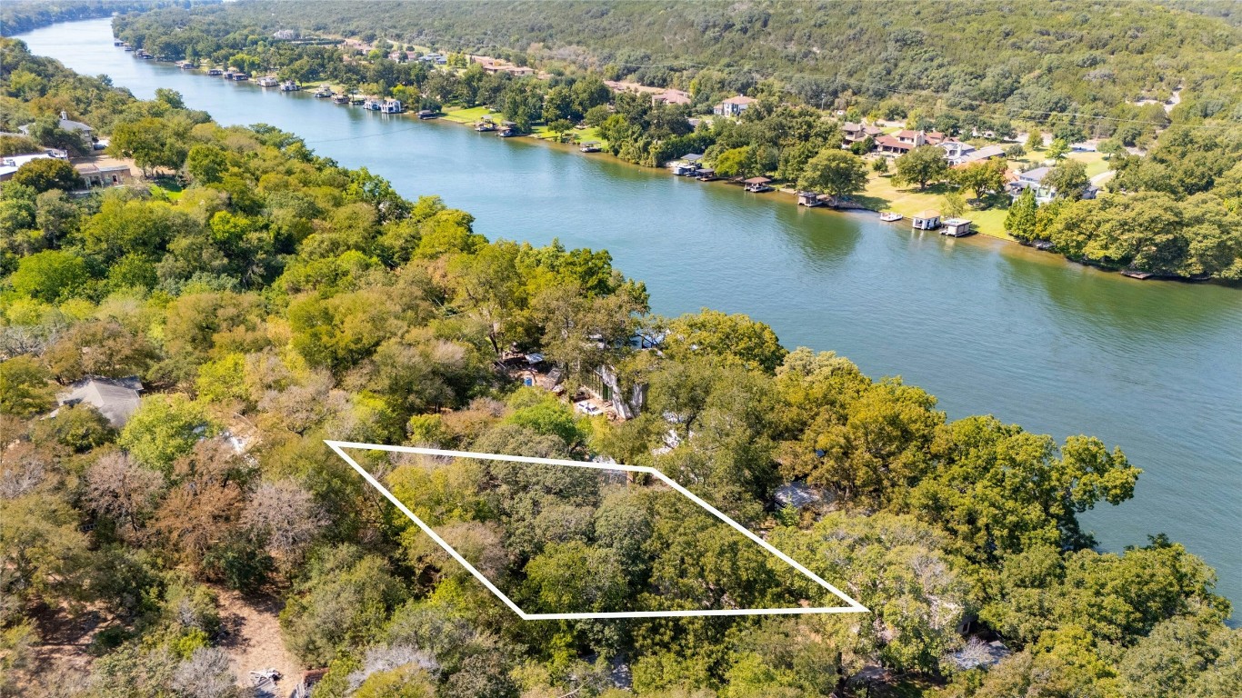 an aerial view of house with yard and ocean view