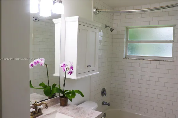 a front view of a house with potted plants