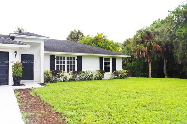a view of a house with a yard and plants