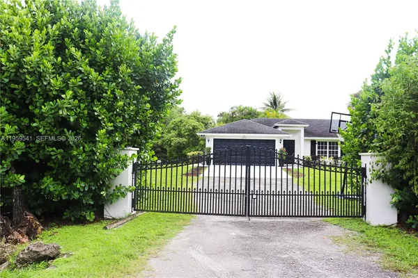 a view of a house with a small yard and plants