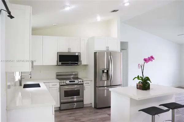 a view of a dining room with furniture wooden floor and chandelier