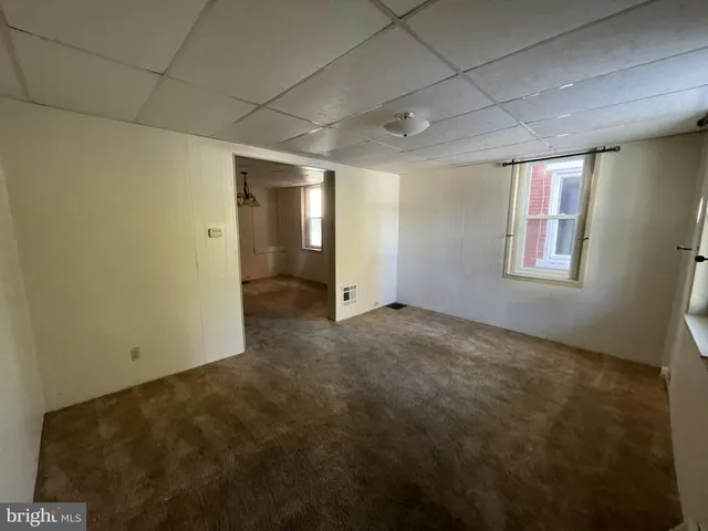 an empty room with windows and closet
