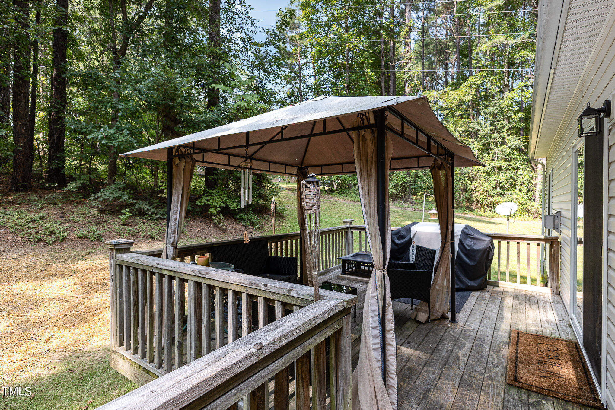 104 Dove Road Creedmoor, NC 27522 - Photo 7 of 25 a view of backyard with deck and outdoor seating