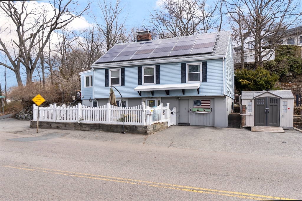159 Jenness Street Lynn, MA 01904 - Photo 2 of 36 a view of a house with a patio and a yard