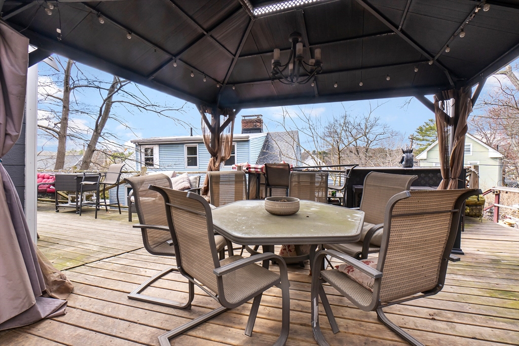 159 Jenness Street Lynn, MA 01904 - Photo 35 of 36 a view of a patio with table and chairs under an umbrella