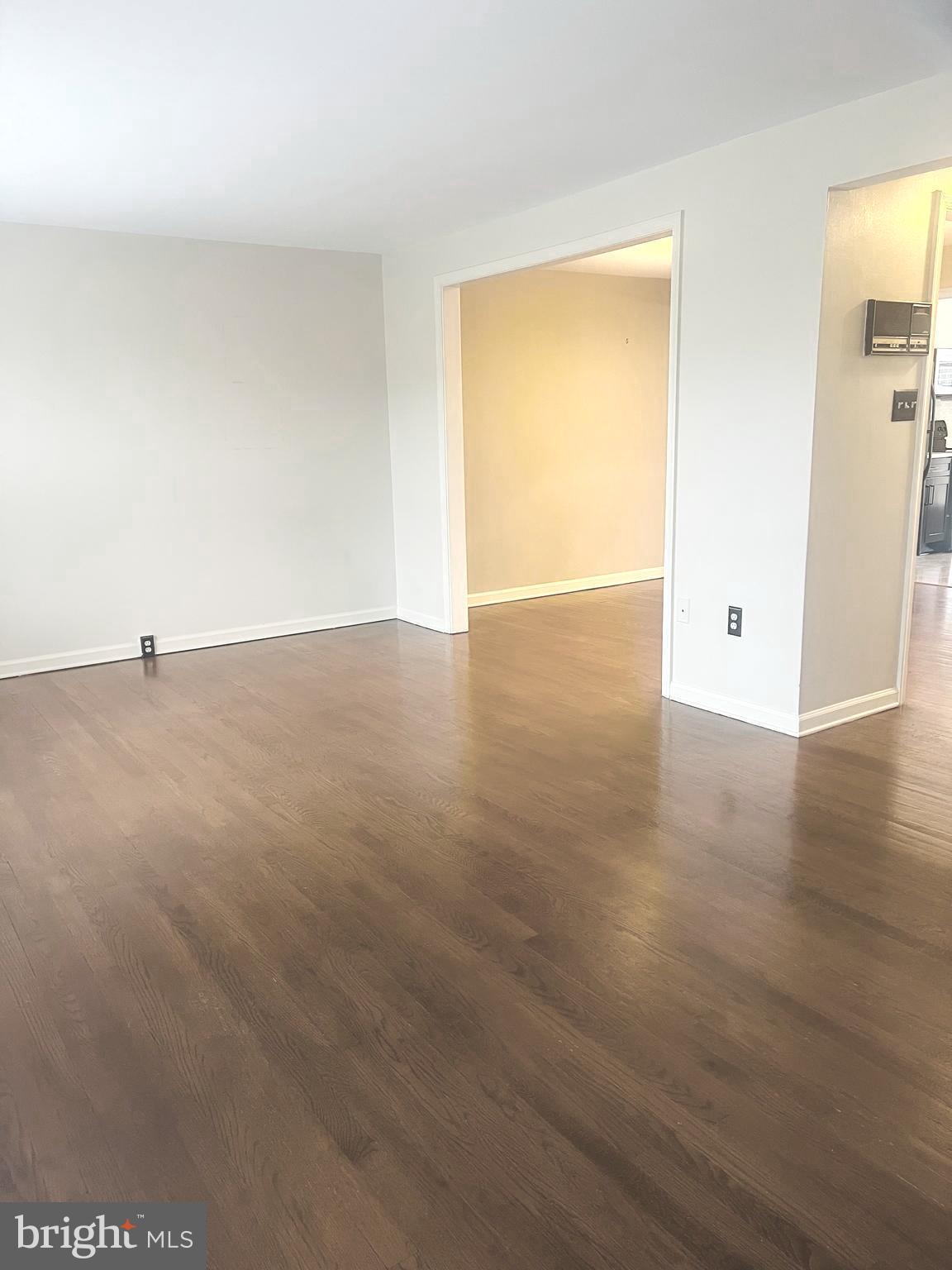 8024 Hollow Reed Court Frederick, MD 21701 - Photo 12 of 31 an empty room with wooden floor and windows