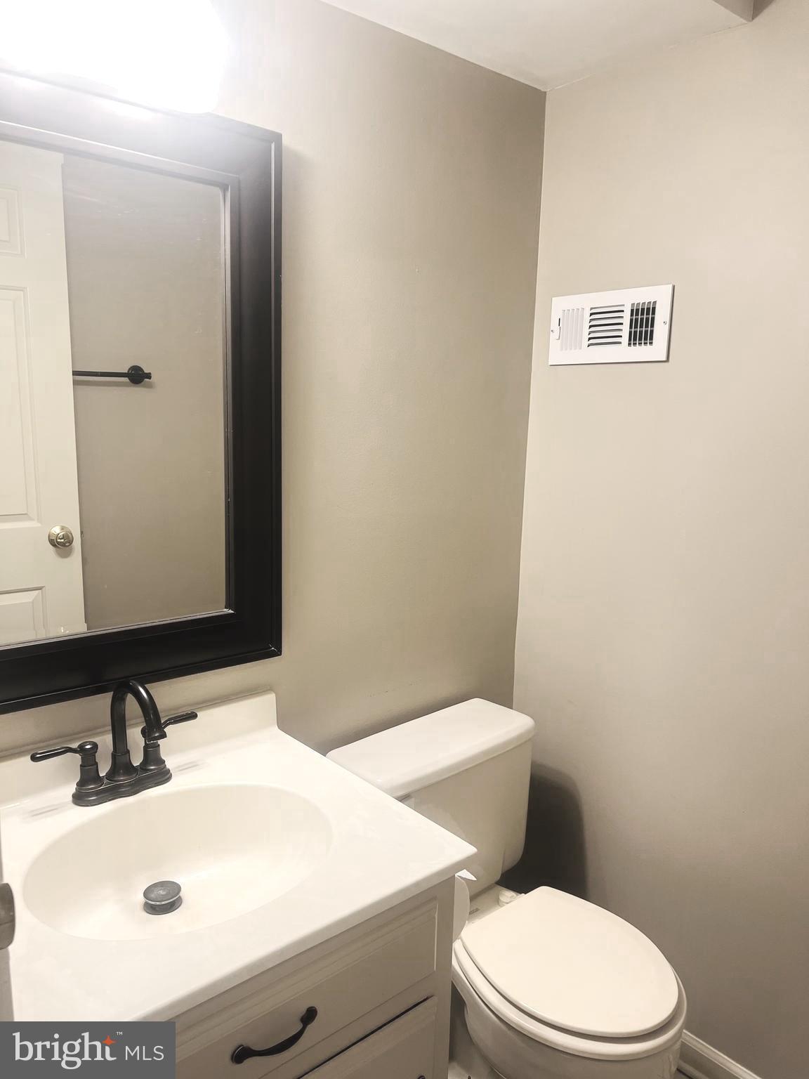 8024 Hollow Reed Court Frederick, MD 21701 - Photo 13 of 31 a bathroom with a sink a toilet and mirror