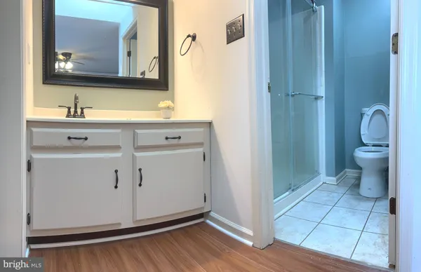 a white toilet sitting next to a white wall