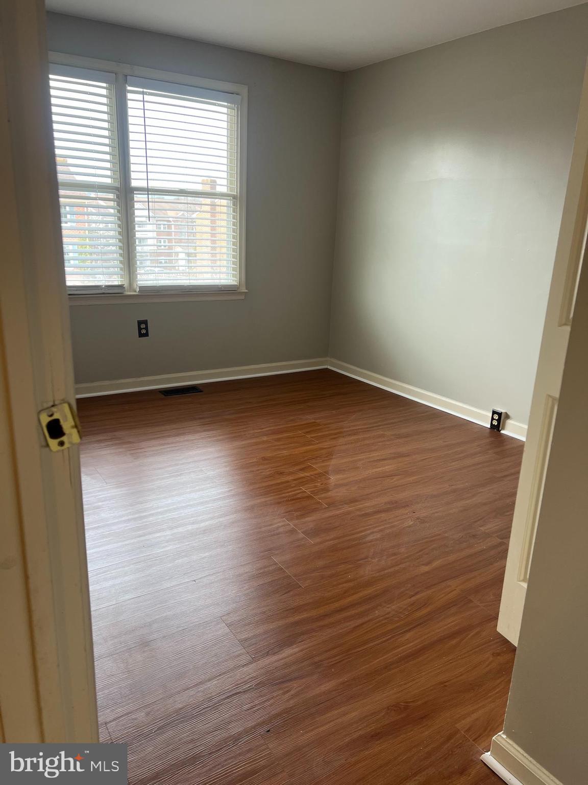 8024 Hollow Reed Court Frederick, MD 21701 - Photo 20 of 31 an empty room with wooden floor and windows