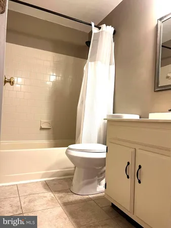 a view of a room with wooden floor and windows