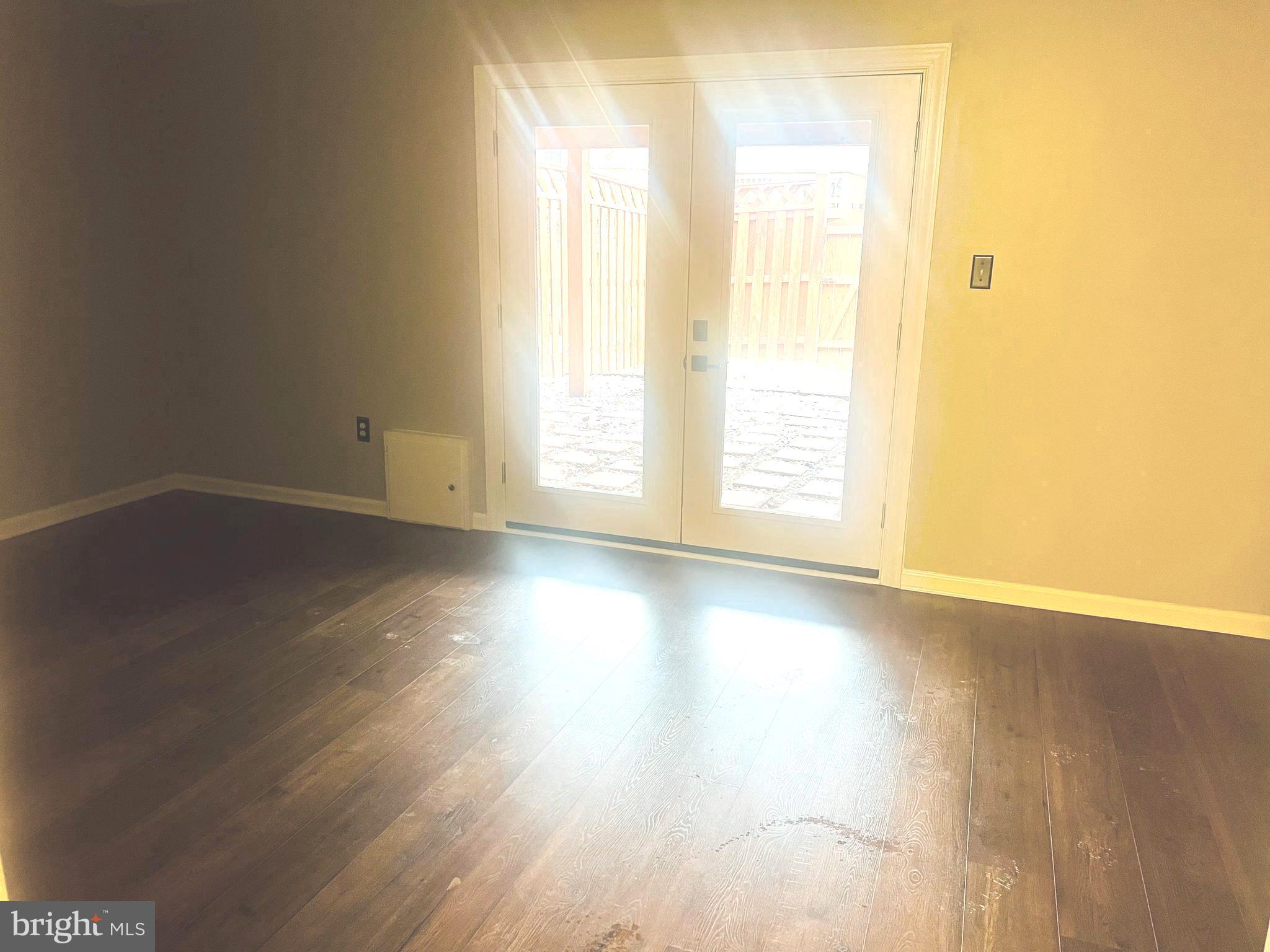 8024 Hollow Reed Court Frederick, MD 21701 - Photo 23 of 31 a view of an empty room with wooden floor and a window