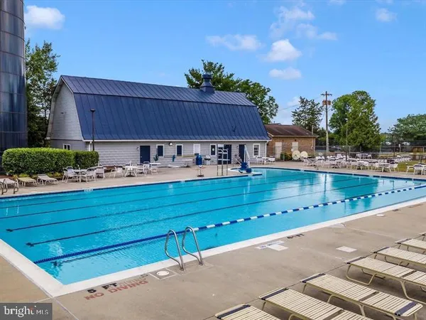 a view of a backyard with swimming pool