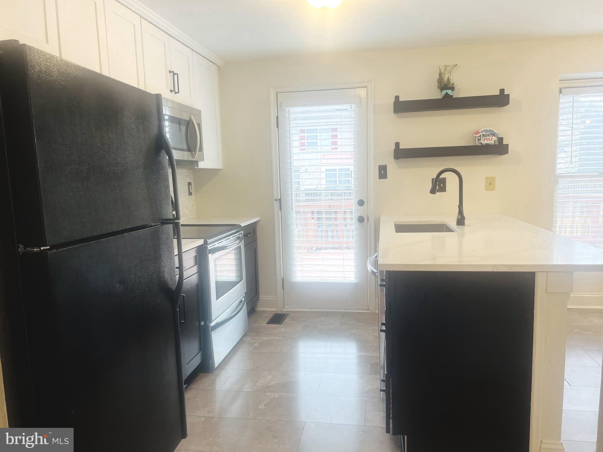 8024 Hollow Reed Court Frederick, MD 21701 - Photo 5 of 31 a kitchen with a refrigerator and a sink