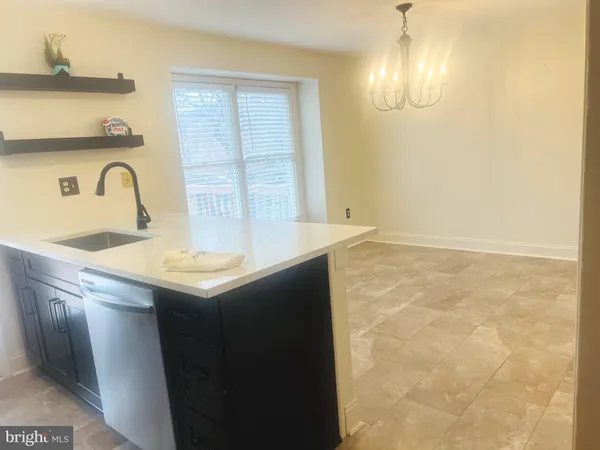 a kitchen with a sink a microwave a stove and refrigerator