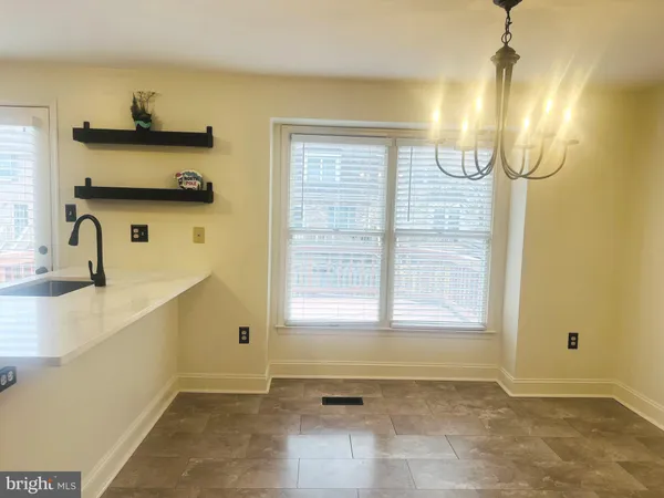 en empty room with wooden floor and windows