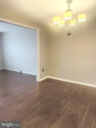 a view of a livingroom with wooden floor and a window