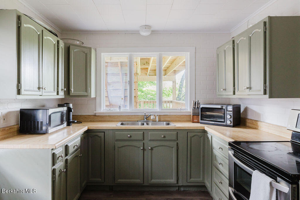 168 Main Street Sheffield, MA 01257 - Photo 15 of 55 a kitchen with a sink stove top oven and microwave