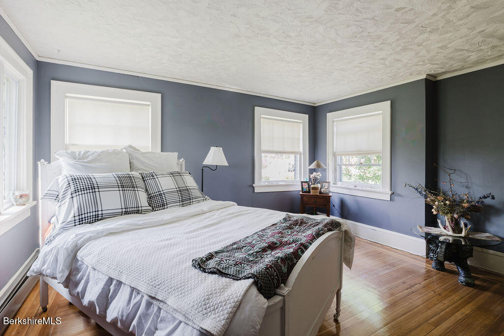 168 Main Street Sheffield, MA 01257 - Photo 36 of 55 a bedroom with a bed and wooden floor