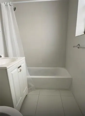a bathroom with a bathtub and a window
