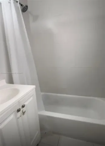 a close up of a bathtub with a shower