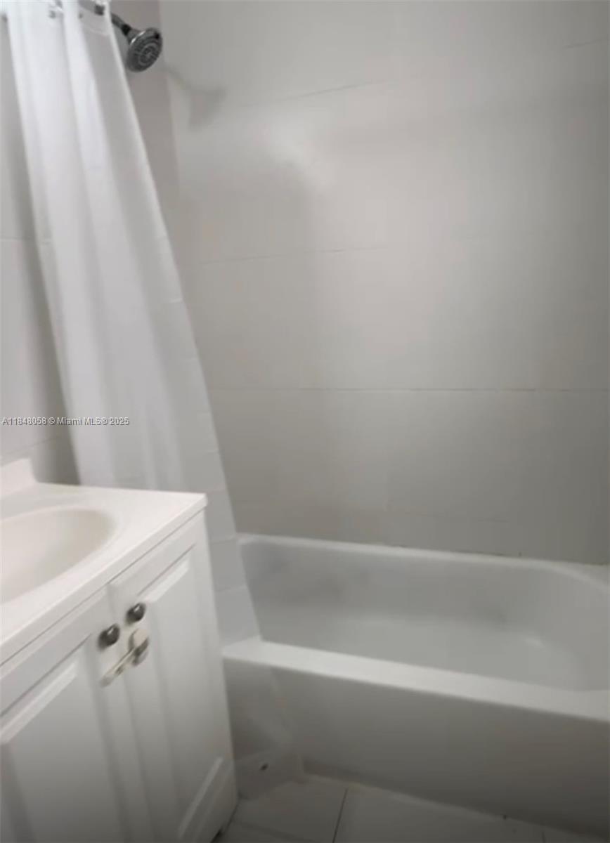 1611 Pennsylvania Avenue, Unit 12A Miami Beach, FL 33139 - Photo 3 of 4 a close up of a bathtub with a shower