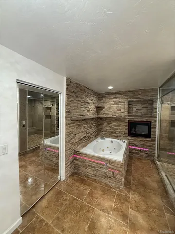 a bathroom with a bathtub and shower
