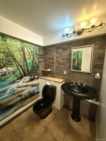 a bathroom with a glass shower door and a sink