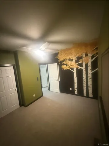 a bathroom with a granite countertop toilet and a sink