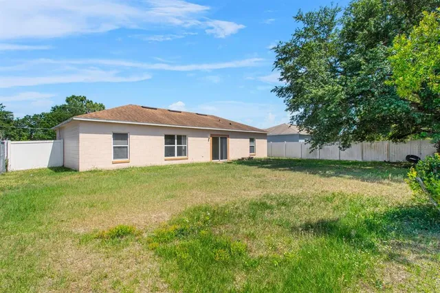 a view of a house with a backyard