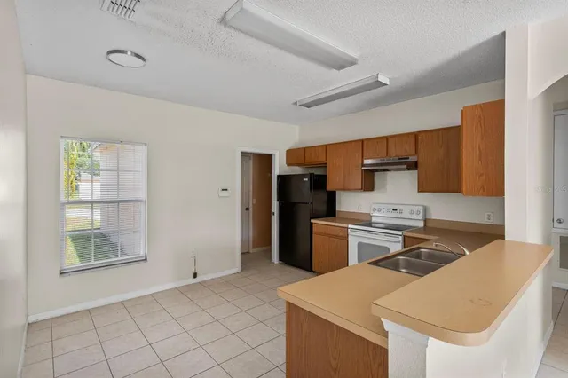 a kitchen that has a cabinets and a stove top oven