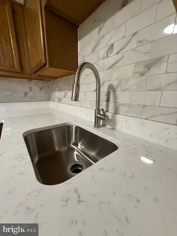 a view of an empty room with window and stairs