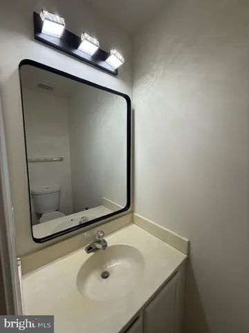 a bathroom with a double vanity sink toilet and shower