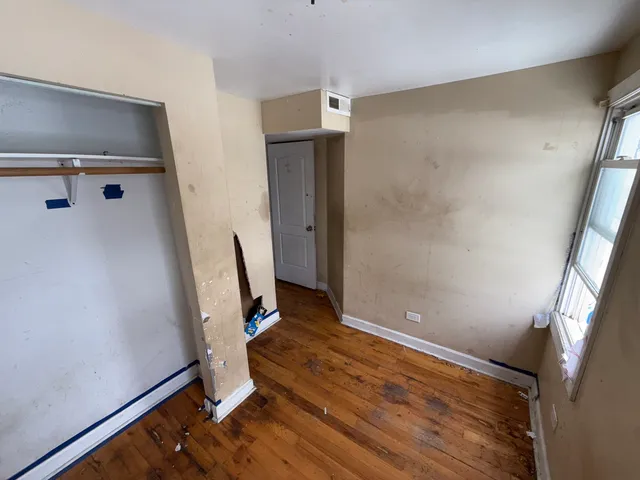 a view of a room with wooden floor and white walls
