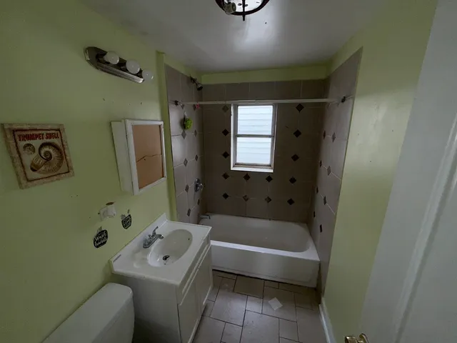 a bathroom with a bathtub sink and toilet